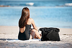 Young woman sitting on beach, peace by the ocean horizon on summer holiday and Mauritius vacation. Female tourist relaxing at sea, freedom of travelling alone and peaceful content in outdoors