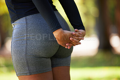 Buy stock photo Stretching, hands and butt of woman at park for health, wellness and flexibility. Sports, training and female athlete outdoors in nature preparing, warm up and getting ready for workout or exercise.