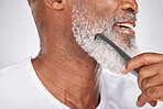 Elderly, black man and comb for beard, beauty and grooming with hygiene and cleaning face zoom. Hair care, brush body hair and wellness with cosmetic care and natural against studio background