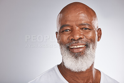 Buy stock photo Senior black man, face and self care with skincare, dermatology and cosmetics for clean, glow and fresh skin. Headshot of African male with a beard on grey studio background for beauty spa treatment