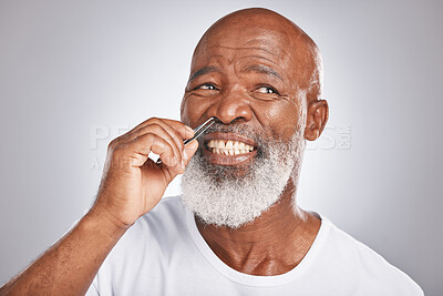 Black man, nose hair and tweezer pain for self care, hair removal and  epilation for beauty and grooming. Headshot of Senior male with beard on  grey background for body care, hygiene and