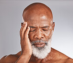 Elderly black man, headache and pain with stress and mental health against studio background. Depression, skin and senior man face with healthcare problem, retirement and anxiety with migraine