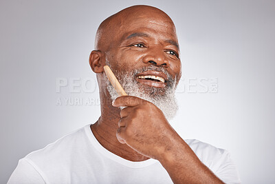 Buy stock photo Elderly, black man with comb for beard, beauty and grooming with hygiene and cosmetic care against studio background. Hair care mockup, brush body hair and face with hair treatment and cosmetics