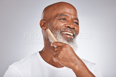 Buy stock photo Elderly, black man with comb for beard, beauty and smile for grooming with hygiene and cosmetic with studio background. Hair care mockup, brush body hair and face with hair treatment and cosmetics
