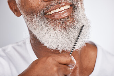 Buy stock photo Elderly, black man with comb for beard, beauty and grooming zoom with face hygiene and cosmetic care. Facial hair closeup, brush body hair and treatment with cosmetics  against studio background