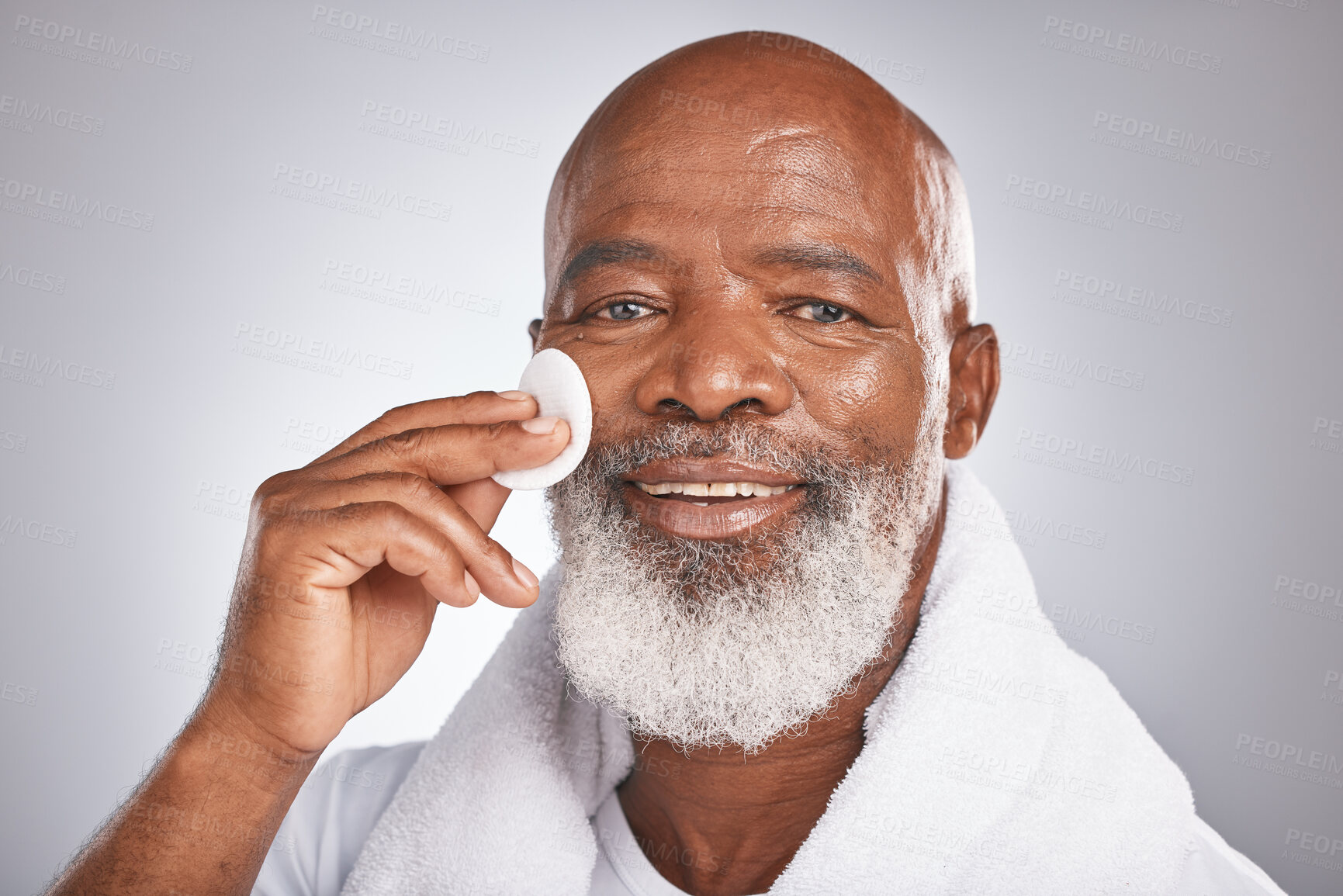 Buy stock photo Portrait, cosmetics and black man with facial cotton, skincare and dermatology on grey studio background. African American guy, senior male and makeup pads for face detox, beauty and luxury self care