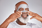 Senior, hands or black man with facial cream marketing or advertising a luxury beauty product for self care. Studio background, cosmetics or African old man with a happy smile applying facial mask