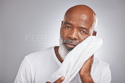 Buy stock photo Portrait, towel or old man cleaning face in studio with marketing or mock up space for skincare beauty. Wellness, glowing skin or healthy senior black man grooming with facial cosmetics or product