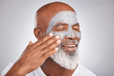 Buy stock photo Skincare, face or senior black man with cream marketing or advertising a luxury beauty product for self care. Studio background, cosmetics or African old man with a happy smile applying facial mask