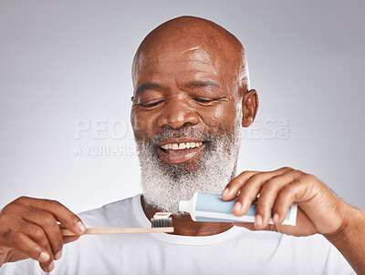 Buy stock photo Dental, toothbrush and product with face of black man for oral hygiene, teeth cleaning and self care. Beauty, cosmetics and grooming with senior model and toothpaste for brushing teeth and health