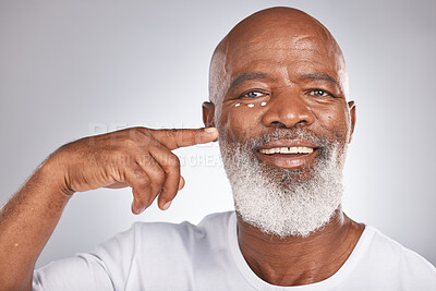 Buy stock photo Beauty, face cream and skincare of black man in studio for self care with skincare, dermatology and cosmetics. Portrait of happy senior male with lotion on skin for glow, health and wellness on grey