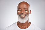 Beauty, facial cream and skincare of black man in studio for dermatology, cosmetics and self care on grey. Face of happy senior male with sunscreen or lotion on skin for glow, health and wellness