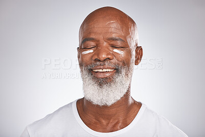 Buy stock photo Beauty, facial cream and skincare of black man in studio for dermatology, cosmetics and self care on grey. Face of happy senior male with sunscreen or lotion on skin for glow, health and wellness