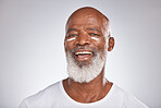 Black man, skincare and facial cream on healthy skin in studio for self care with dermatology and cosmetics product. Face portrait of happy senior male with lotion for glow, health and wellness