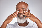 Senior black man, face and self care with facial cream with skincare, dermatology and cosmetics product. Headshot of African male with skin lotion on grey studio background for beauty spa treatment