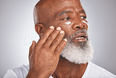 Buy stock photo Beauty, skincare and black man with facial cream for self care with dermatology and cosmetic product. Face of senior male healthy skin on grey studio background for grooming and spa treatment