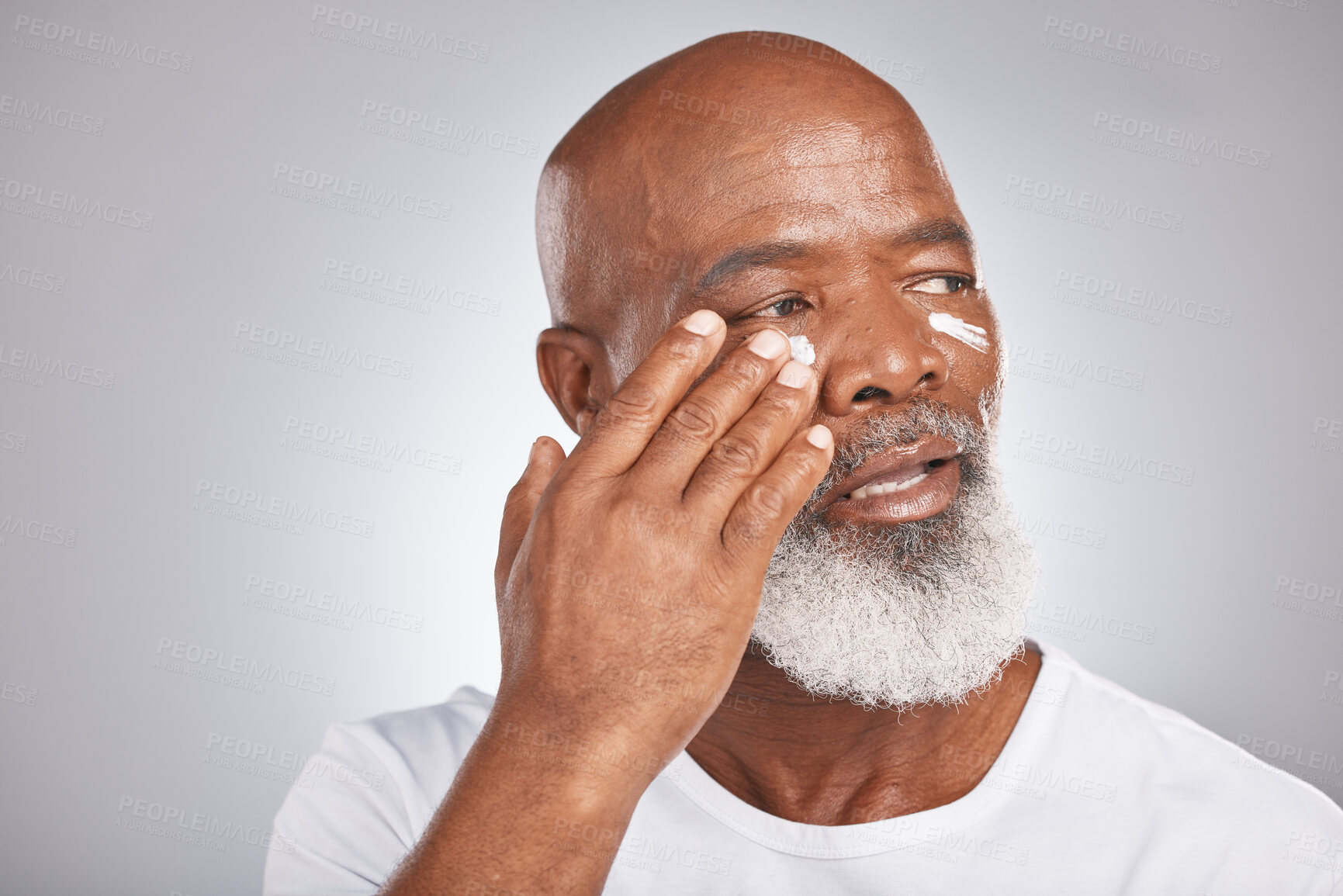 Buy stock photo Skincare, beauty or old man with facial cream marketing or advertising luxury beauty product for self care. Studio background, mockup space or senior black mans hand applying facial mask or cosmetics