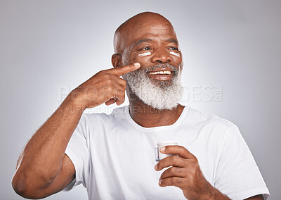 Buy stock photo Black man, beauty and skincare with facial cream on skin with dermatology and cosmetics for healthy glow. Face of senior male with sunscreen or lotion container on grey studio background for wellness