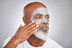 Skincare, hand or old man with facial cream marketing or advertising a luxury beauty product for self care. Studio background, cosmetics or senior black man applying face mask for clean glowing skin