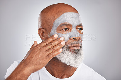Buy stock photo Skincare, hand or old man with facial cream marketing or advertising a luxury beauty product for self care. Studio background, cosmetics or senior black man applying face mask for clean glowing skin
