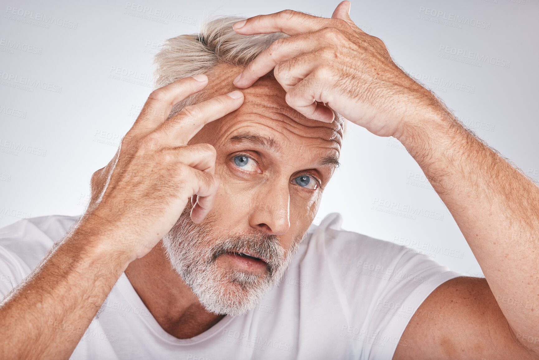 Buy stock photo Skincare, health and man pop a pimple before a cosmetic, beauty or self care treatment in a studio. Wellness, cosmetics and senior guy doing a face routine for a blemish isolated by a gray background