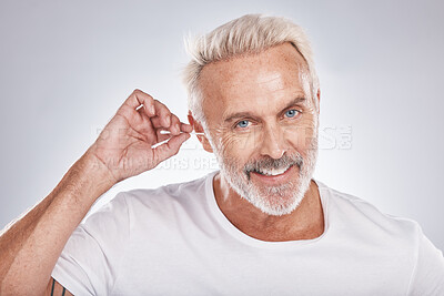 Buy stock photo Senior man, cotton bud and ear cleaning or happy portrait in white studio background for grooming hygiene, wellness and wax removal. Elderly model, cosmetics ears cleaner and body care happiness