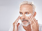 Skincare, eyes patch and man in studio for dermatology facial, face cosmetics or collagen mask advertising or marketing mockup. Senior model, hands application and eye patches or anti aging product
