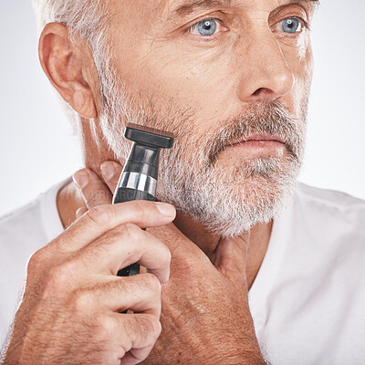 Buy stock photo Senior man, shaving and electric razor for hair care, beauty and cosmetics on studio background. Mature male, elderly guy and shave for facial routine, beard trim and wellness for health and skincare