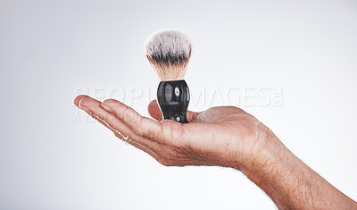 Buy stock photo Makeup, cosmetics and hand of man with brush in studio isolated on a gray background mockup. Skincare, aesthetics and male model holding product, accessory or tool for grooming, beauty and wellness.