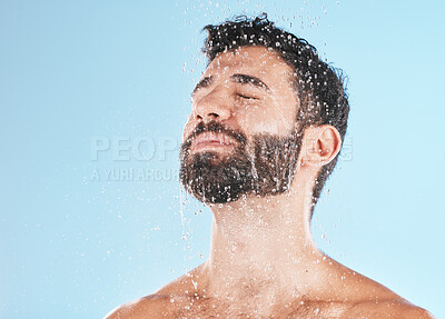 Buy stock photo Man shower, cleaning face and studio for self care wellness, relax and beauty by blue background. Model, skincare and water drop on facial, beard and self love for health, body or clean by backdrop