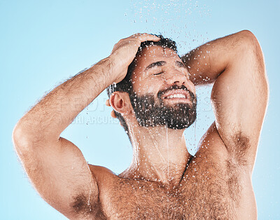 Buy stock photo Shower, grooming and a man cleaning his hair with shampoo in studio on a blue background for beauty. Hygiene, washing and bathroom with a handsome male wet with liquid while bathing for haircare