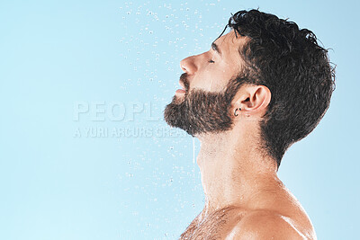 Buy stock photo Shower, man and cleaning face with water and hygiene, grooming and skincare against blue studio background. Clean, model profile with water drops and facial, natural treatment and cosmetic mockup