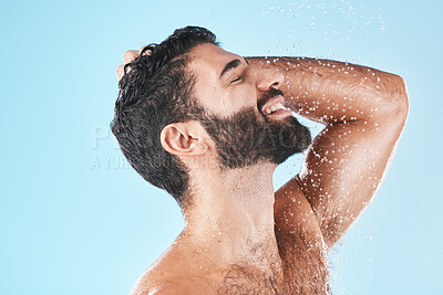 Buy stock photo Skincare, man and shower for wellness, cleaning and hygiene for routine on blue studio background. Arabic male, guy and washing for beauty, natural care and body care for grooming and water splash