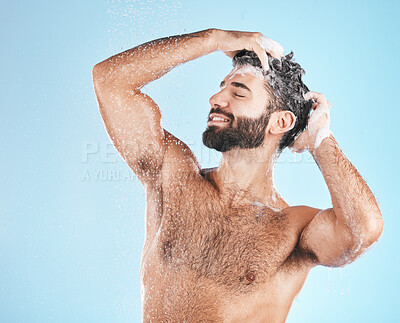 Buy stock photo Hair, shampoo and cleaning with a man in studio on a blue background to take a shower for hygiene. Water, skin and relax with a male washing for haircare or keratin treatment in the bathroom