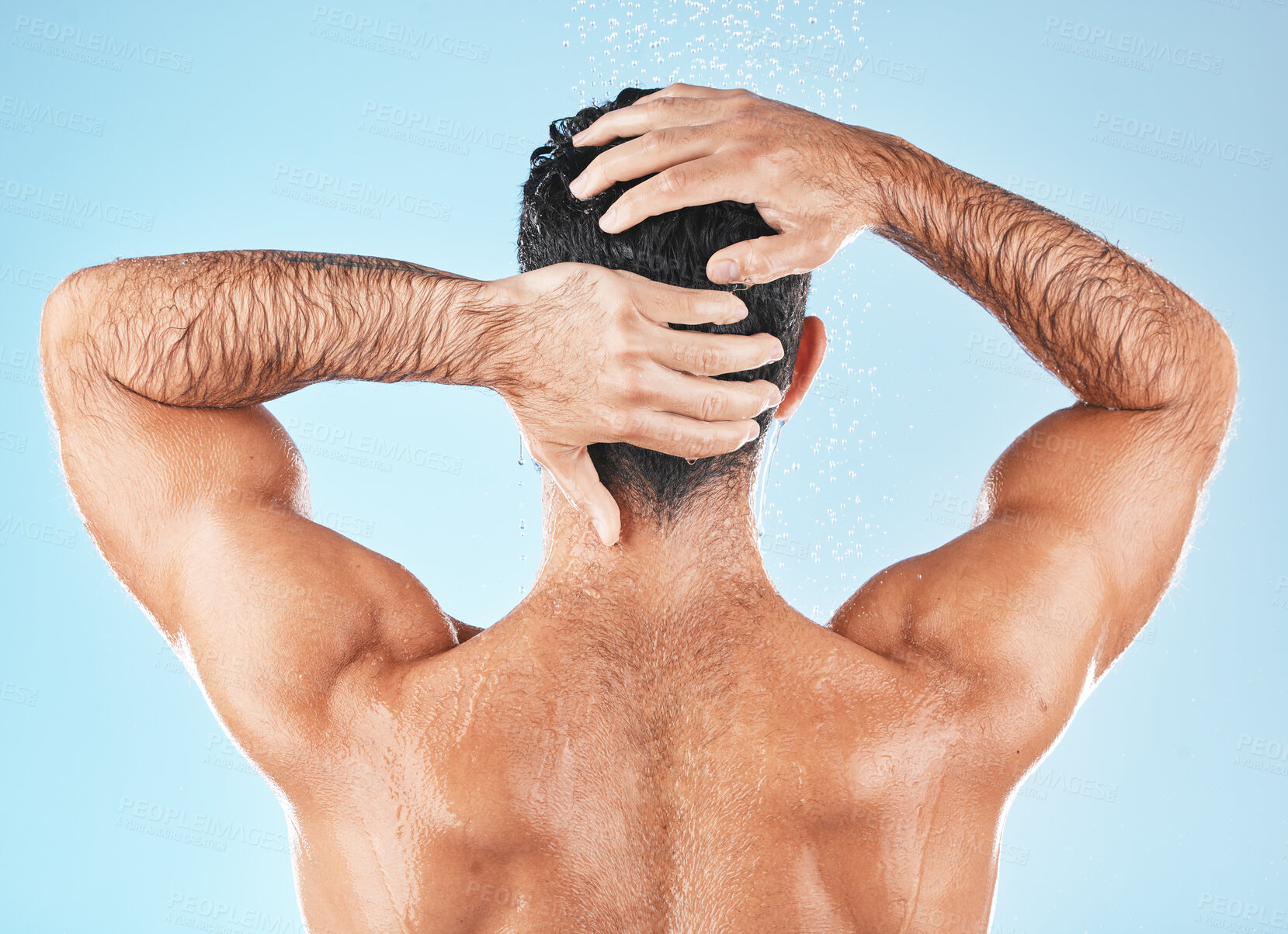 Buy stock photo Water splash, man back and hair care shower for body hygiene, skincare grooming or cleaning care in blue background studio. Model, self care water cleansing and cosmetics wellness for morning routine