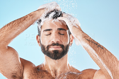 Buy stock photo Hair care, face water splash and shower of man in studio isolated on a blue background. Water drops, shampoo and male model washing, cleaning or bathing for healthy skin, wellness or skincare hygiene