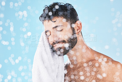 Buy stock photo Man, towel with cleaning face and beauty, bokeh overlay with hygiene and grooming against blue background. Skincare mockup with shower, clean cosmetic care and cotton fabric, facial and wellness