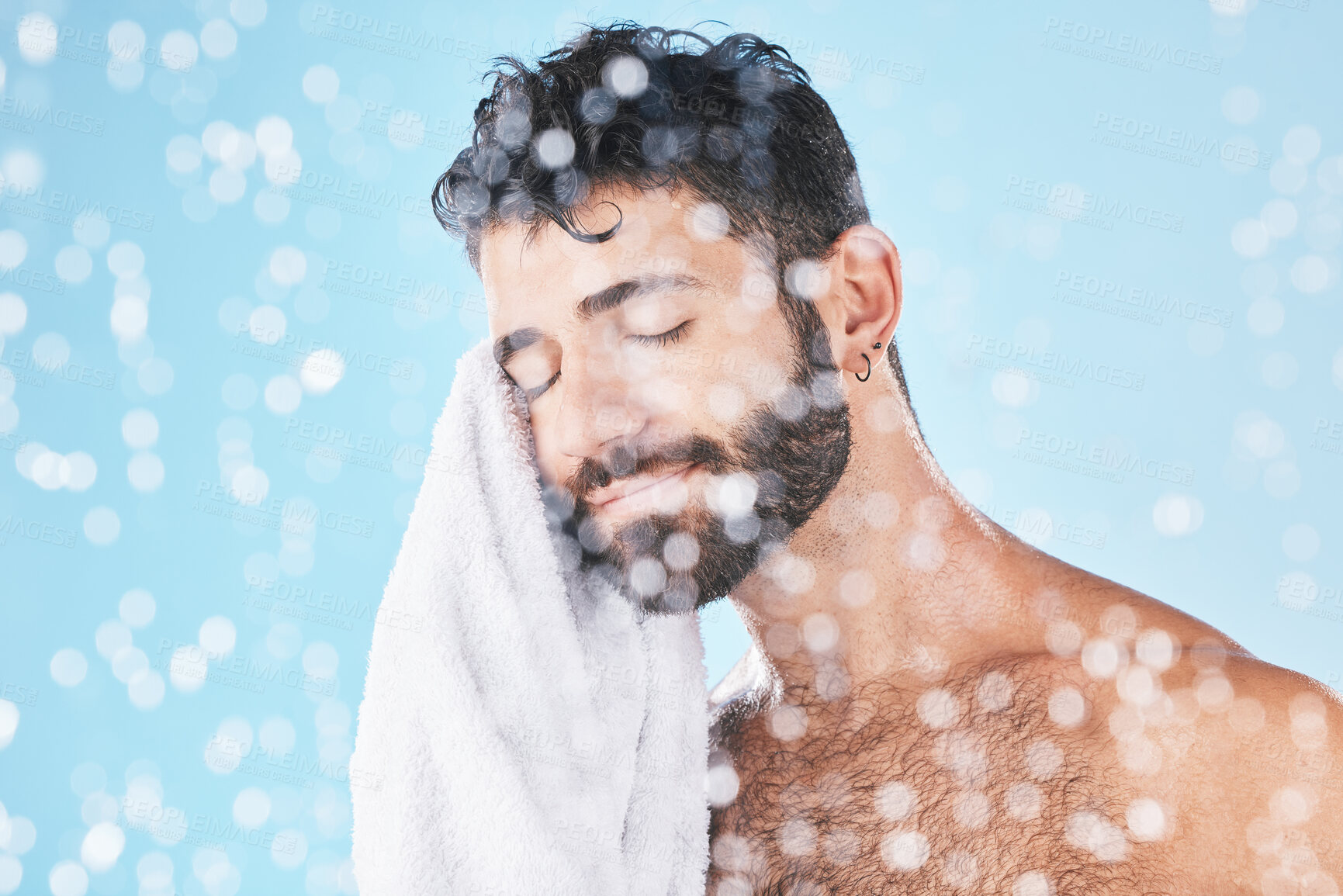 Buy stock photo Man, towel with cleaning face and beauty, bokeh overlay with hygiene and grooming against blue background. Skincare mockup with shower, clean cosmetic care and cotton fabric, facial and wellness