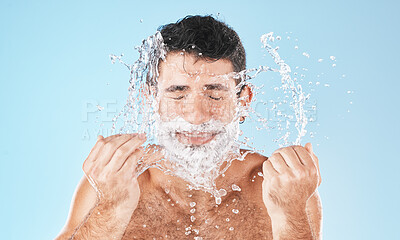 Buy stock photo Man, shave and face with water splash in studio for wellness, health and self care by blue background. Model, bathroom and smile with splash for facial beauty, skin product and cosmetics by backdrop