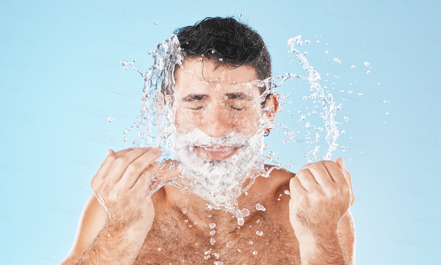 Buy stock photo Man, shave and face with water splash in studio for wellness, health and self care by blue background. Model, bathroom and smile with splash for facial beauty, skin product and cosmetics by backdrop