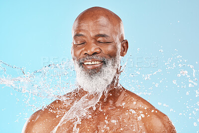 Buy stock photo Relax, senior and black man with skincare cleaning routine and satisfied face with water splash. Mature cosmetic model washing body with smile for grooming hygiene on blue studio background.

