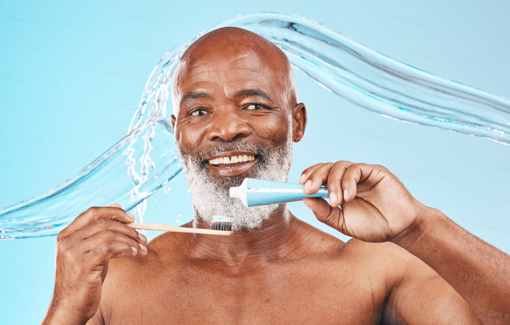 Buy stock photo Water splash, oral hygiene and portrait of a man in a studio for mouth health and wellness. Toothpaste, toothbrush and elderly African guy brushing his teeth for fresh dental care by blue background.