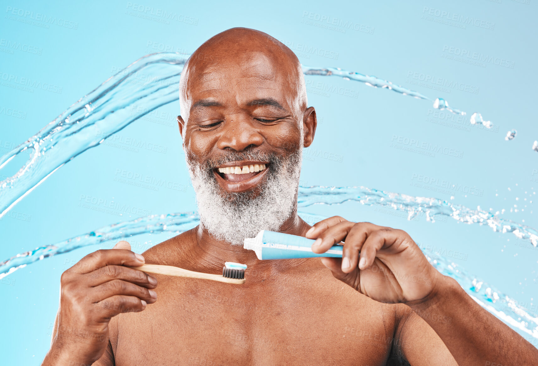 Buy stock photo Face, water splash and black man with toothbrush and toothpaste in studio isolated on blue background. Dental, oral hygiene and senior male model with product for brushing teeth, cleaning and health.