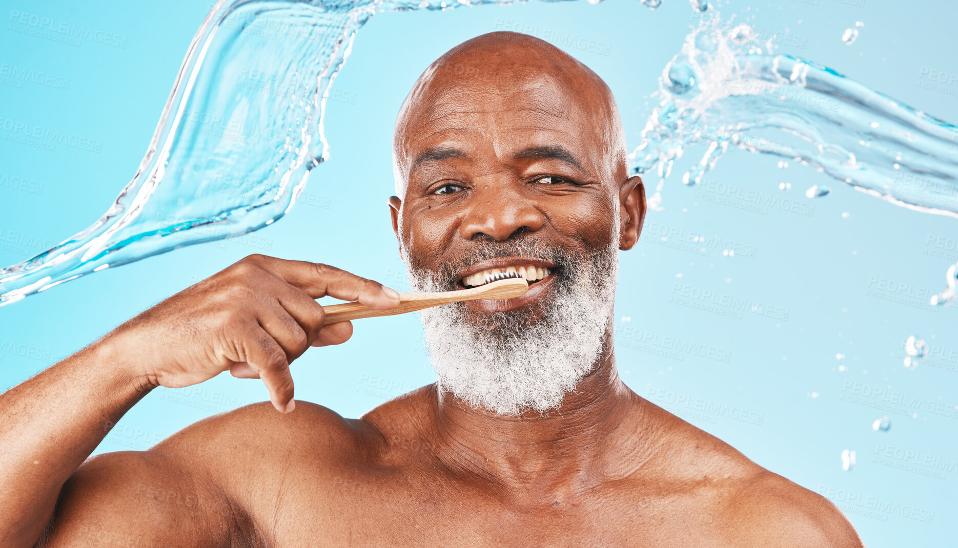 Buy stock photo Black man, dental hygiene and toothbrush with water, wellness and hygiene against blue studio background. Oral health, African American male and mature guy with smile, toothpaste and clean mouth.
