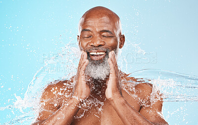 Buy stock photo Face, water and cleaning of happy black man on blue background for wellness, cosmetics and shower. Studio male model, smile and water splash in bathroom for facial health, aesthetic skincare and spa