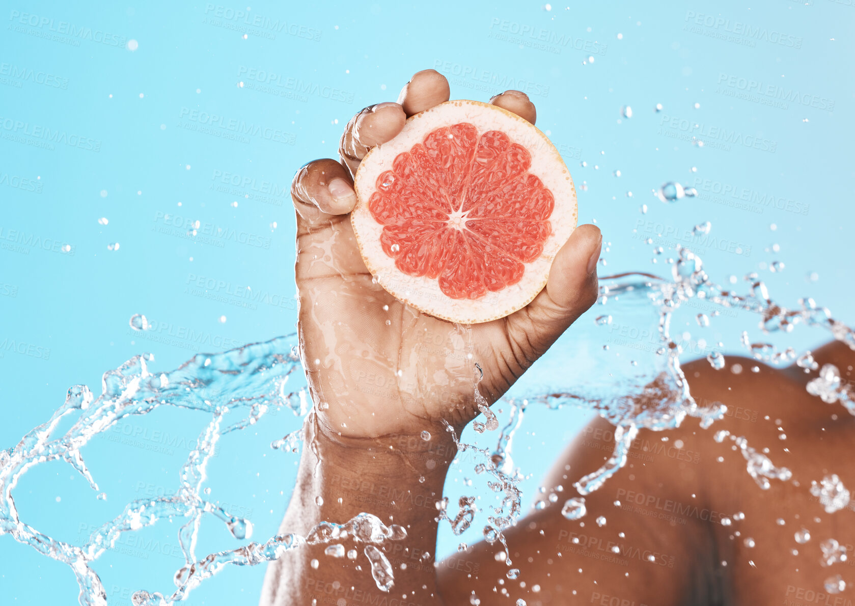 Buy stock photo Water splash, grapefruit in hand and studio background for healthy, vegan and nutrition food on advertising, marketing or promotion mockup. African, shower and juice fruit benefits in clean skincare