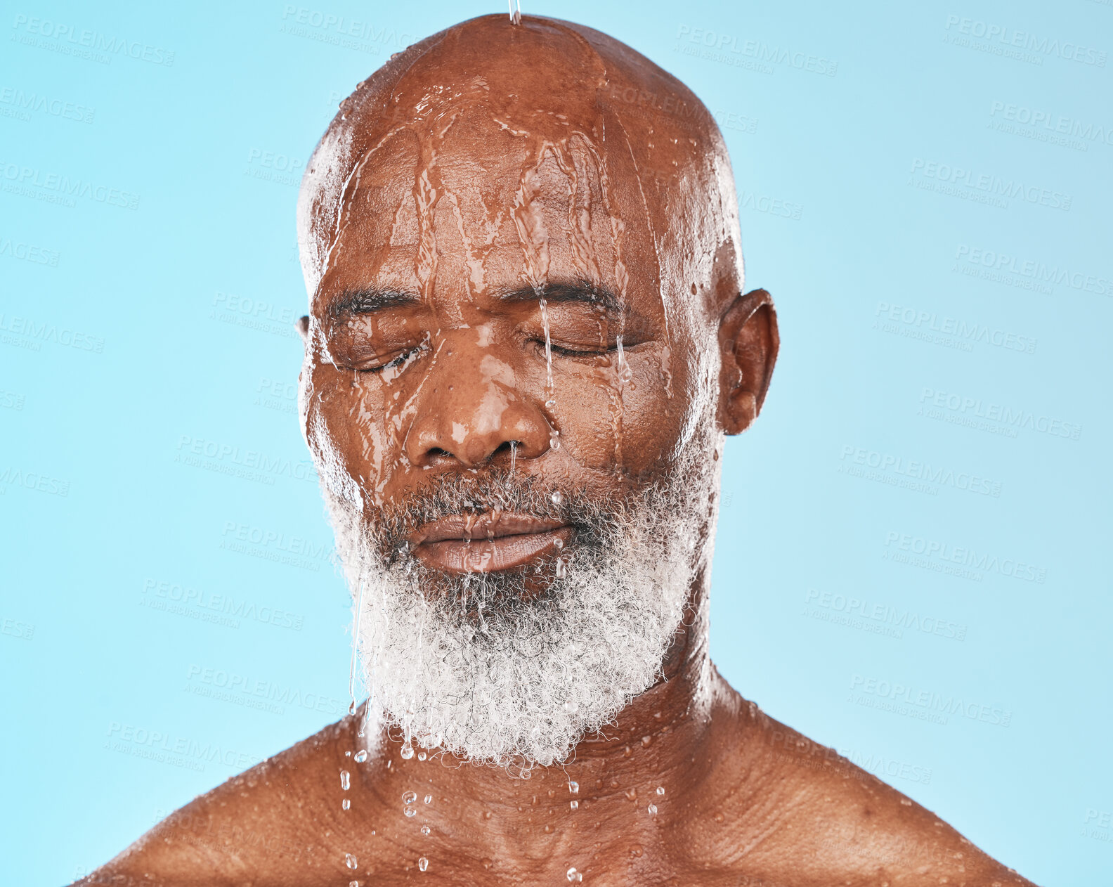 Buy stock photo Shower, black man and water for cleaning, skincare and wellness on blue studio background. Mature male, elderly guy and face wet for hygiene, washing or body care for beauty, cosmetics or clear skin 