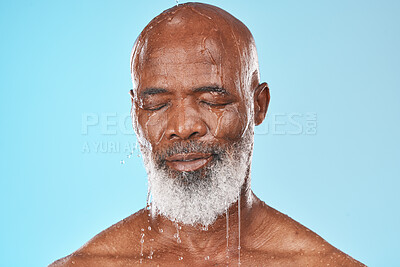 Buy stock photo Black man, face and water drip on studio blue background for wellness, healthy skincare and bathroom hygiene. Male model, wet shower and water drops for mature beauty, facial and fresh body cleaning 