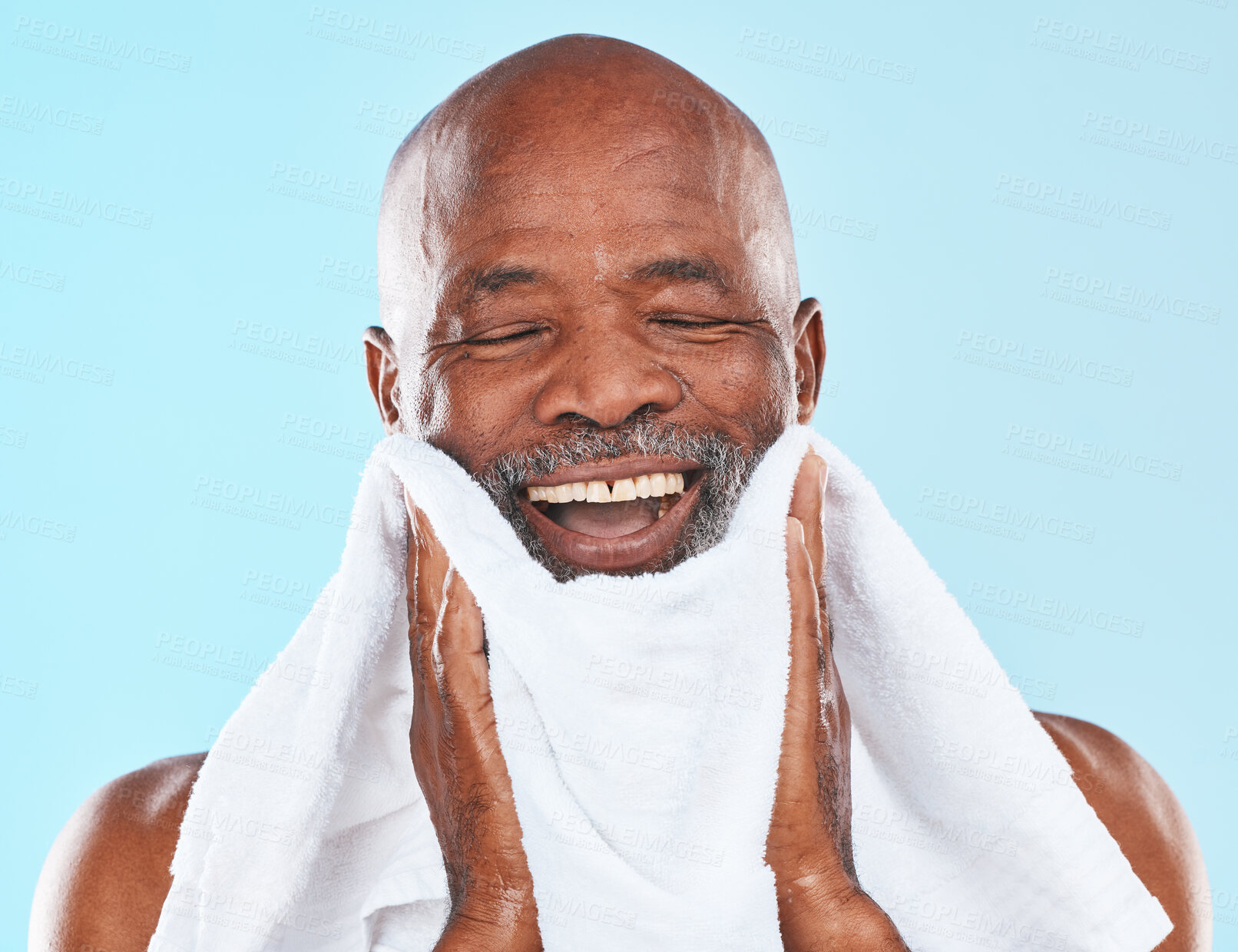 Buy stock photo Black man, studio and towel for shave, smile and wellness for self care, hygiene and beard by blue background. Senior man, happy and cloth for skincare, wellness and grooming routine by backdrop