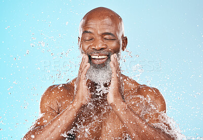 Buy stock photo Water splash, natural routine and cosmetics of black man with facial skincare benefits, transformation or aesthetic glow. Cleaning face, happy guy model and beauty on blue background with water drops